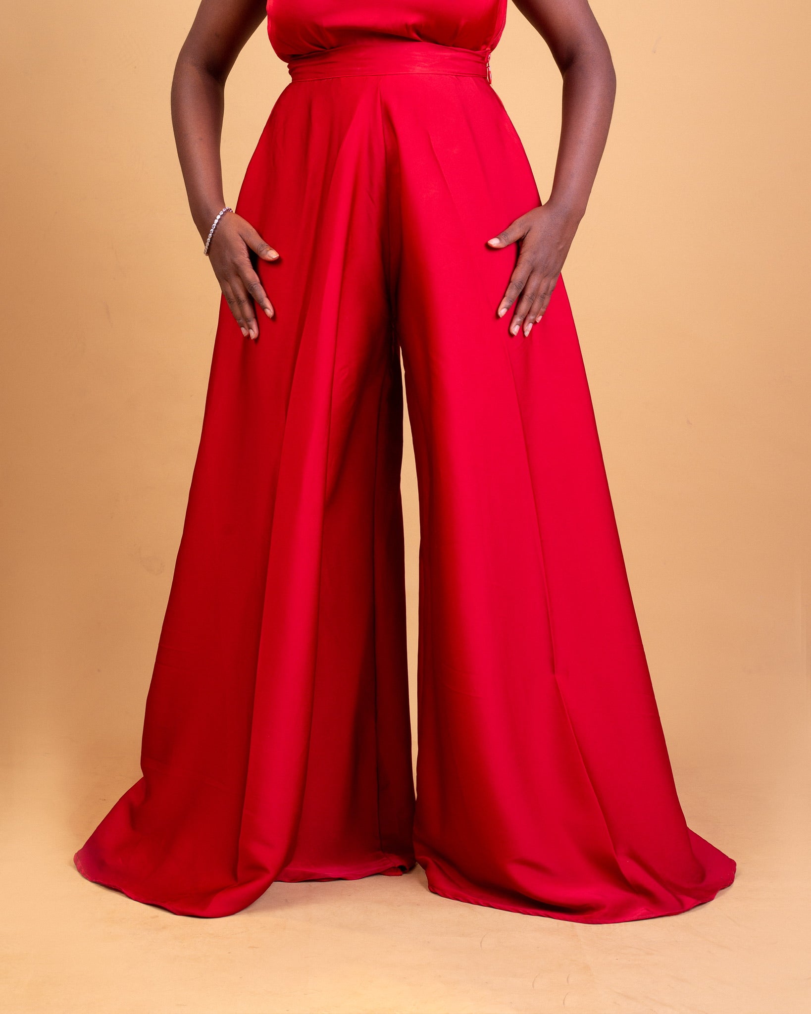 Wide-leg red pants for women, high waisted, flowy fabric, elegant style, studio background